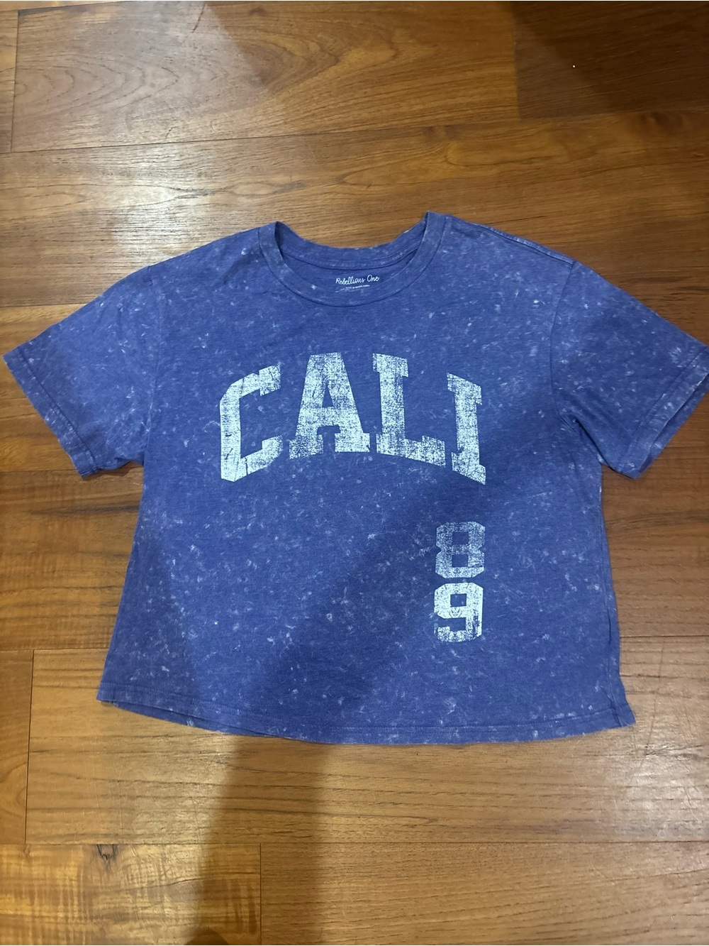 Rebellious One Blue Graphic Crop Tee